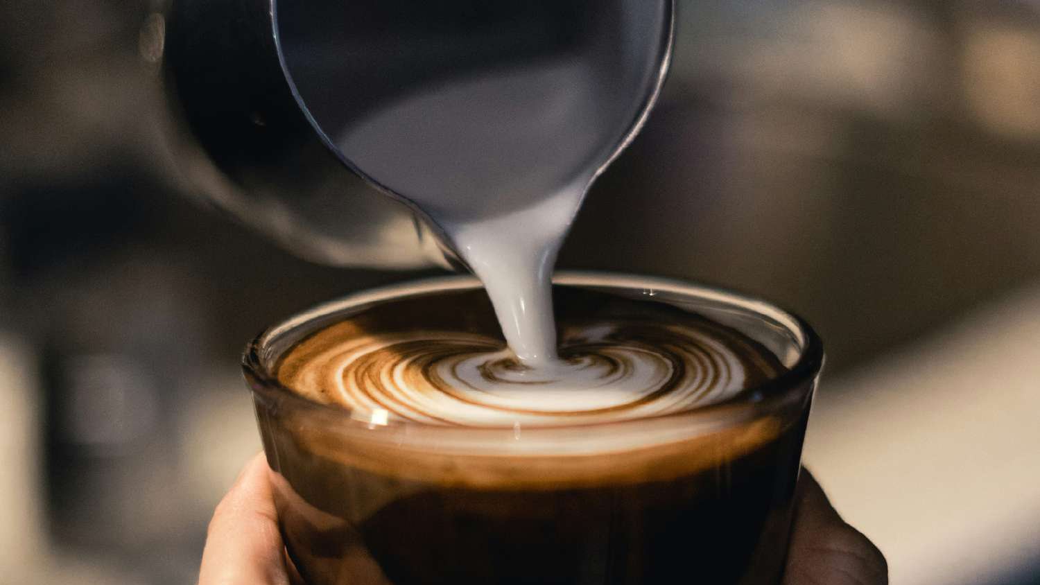 Milk poured into an espresso at a Bianco counter